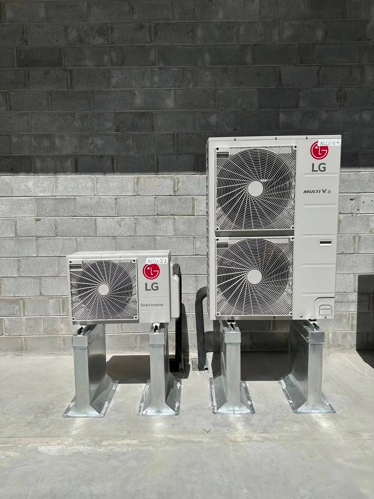 Two LG outdoor units mounted on raised metal supports